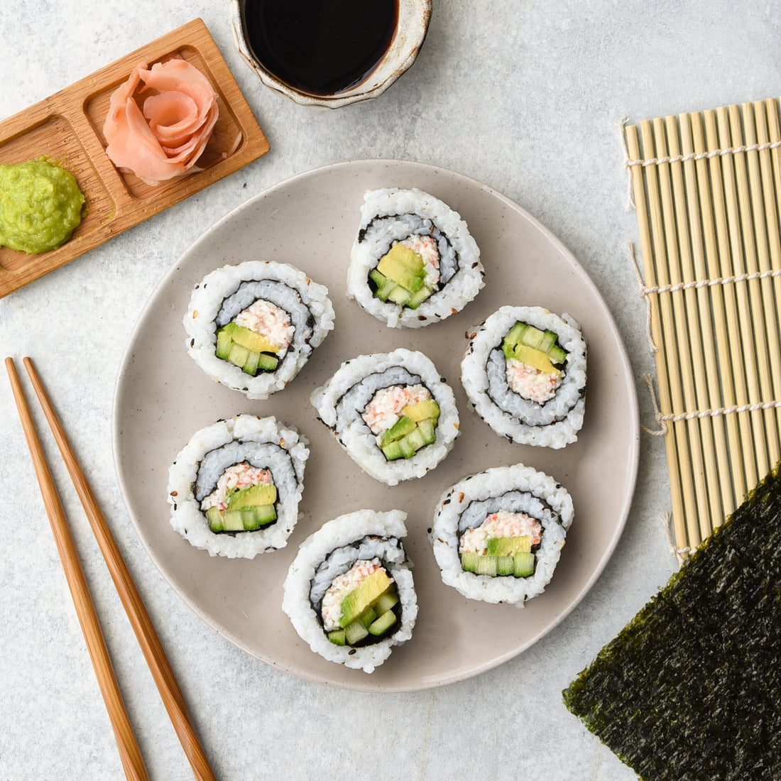 Sliced sushi roll pieces on a plate made with gimme sushi nori seaweed snack.