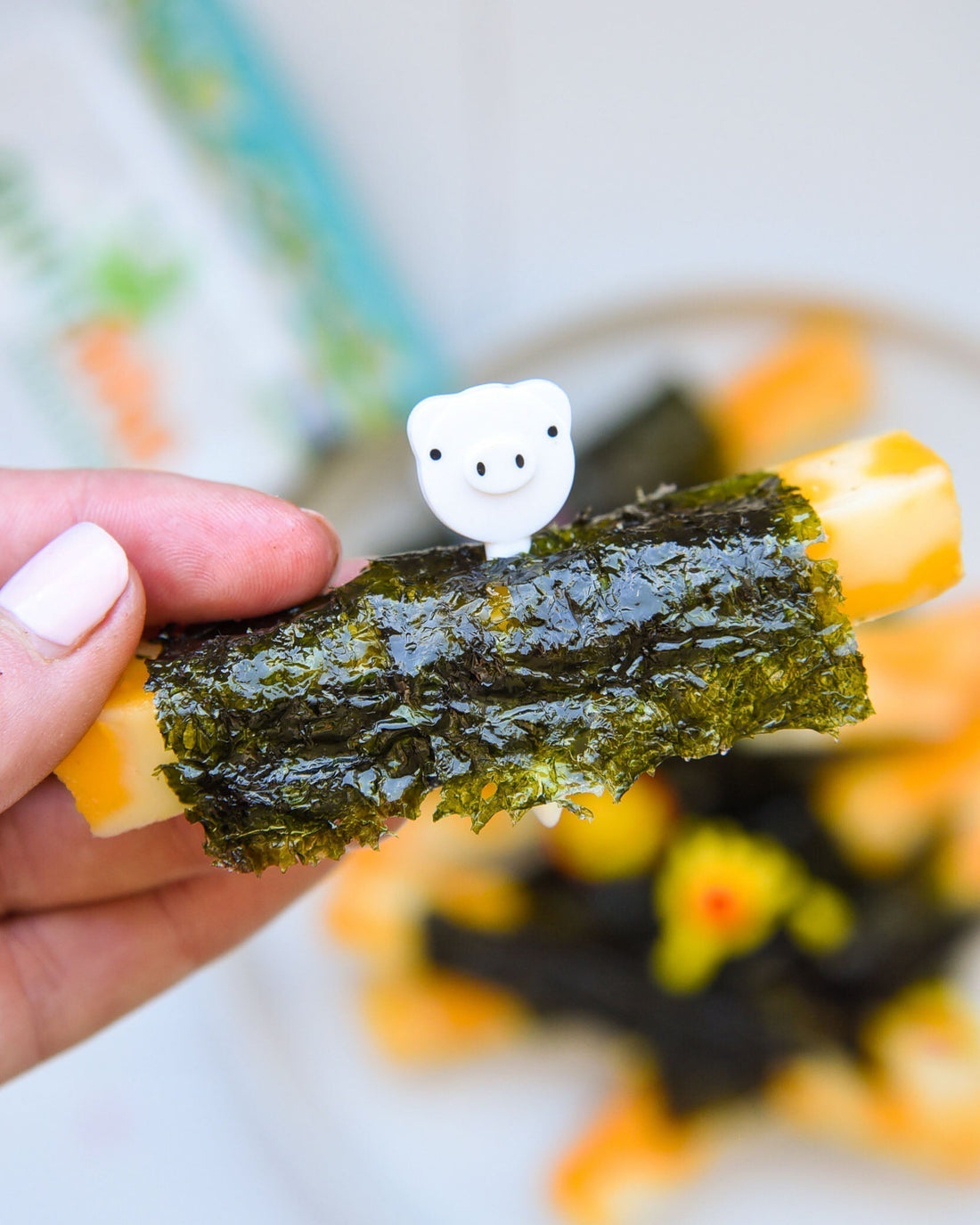 A piece of cheese wrapped in gimme seaweed snack.