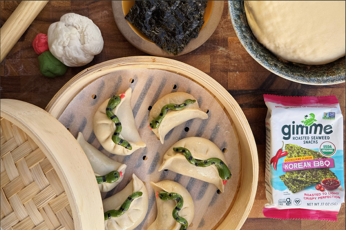 Dumplings on tray next to gimme korean bbq seaweed snack.