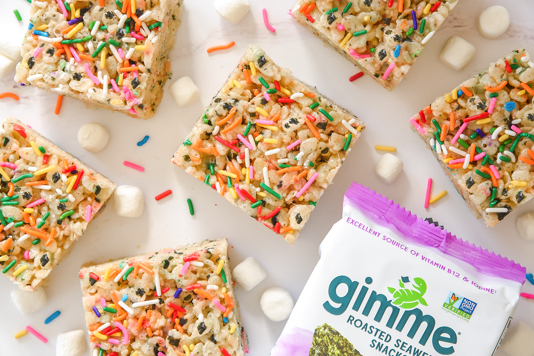 Rice krispy treats with rainbow sprinkles and mini marshmallows next to gimme teriyaki seaweed snack.