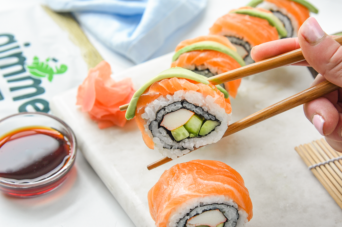 Salmon rainbow sushi roll with gimme sushi nori seaweed snack.