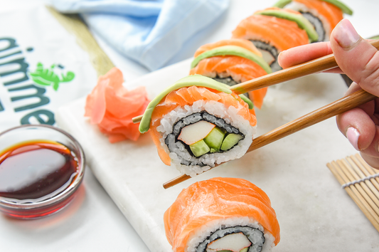 Salmon rainbow sushi roll with gimme sushi nori seaweed snack.