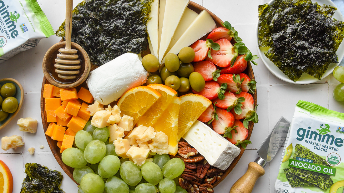 Cheese board with gimme avocado oil seaweed snack.
