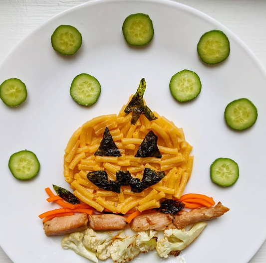 Image of a jack-o-lantern made of mac n cheese and seaweed.