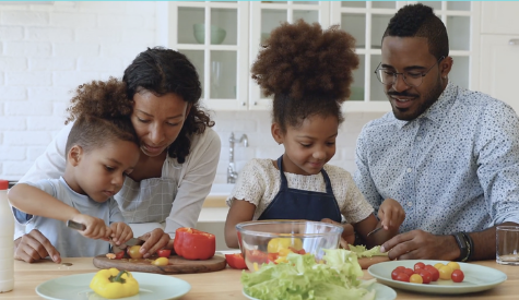 Image of people making food together.
