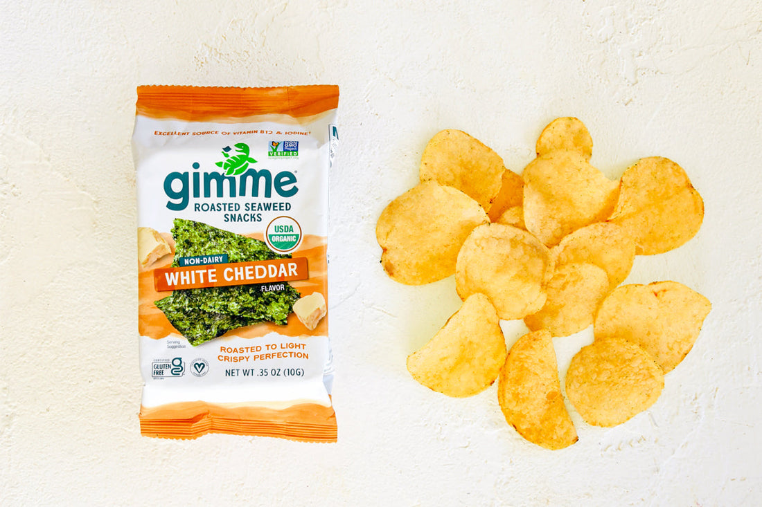 Gimme white cheddar seaweed snack next to potato chips.