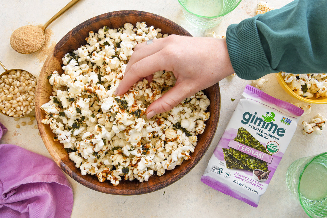 Sweet and salty popcorn with gimme teriyaki seaweed snack.