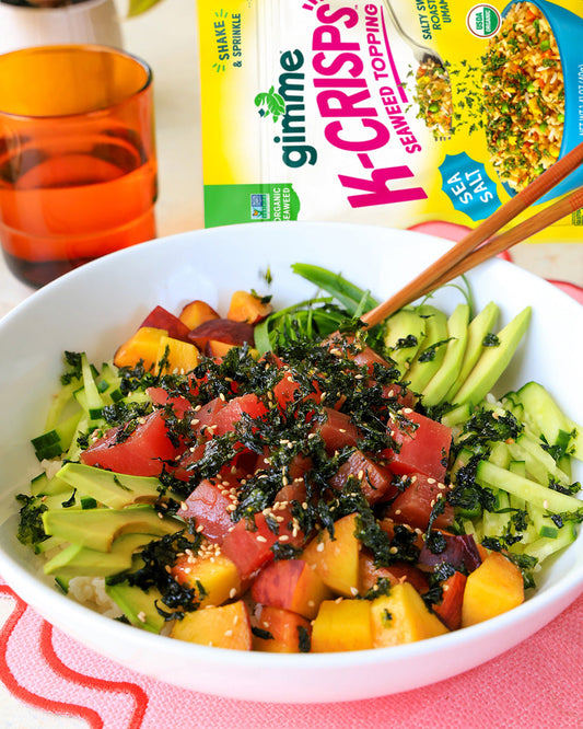 A Summer Poke Bowl with avocado, tuna and peaches topped with Gimme K-Crisps seaweed topping