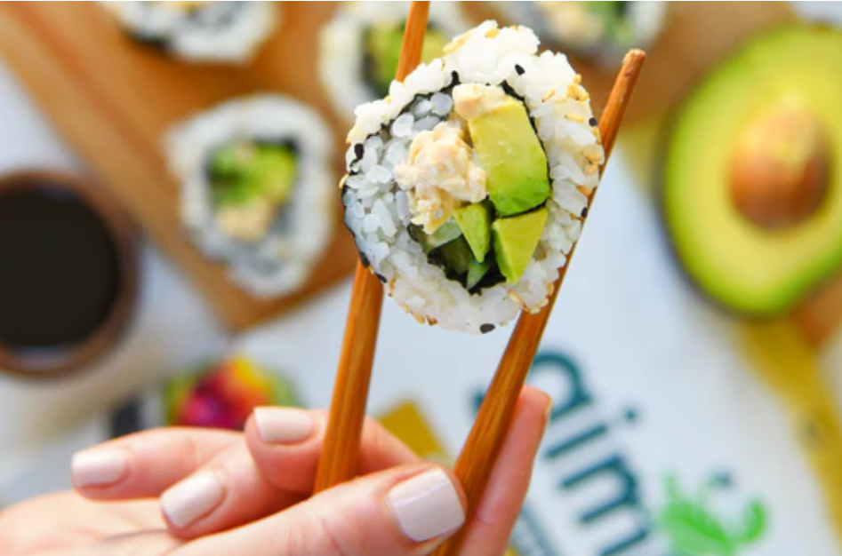 Sushi roll with salmon, avocado and gimme sushi nori seaweed snack.